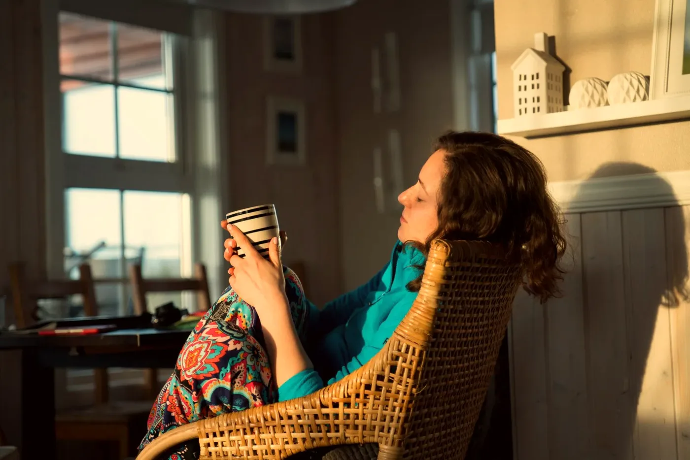 A woman relaxing at home with a cup of coffee